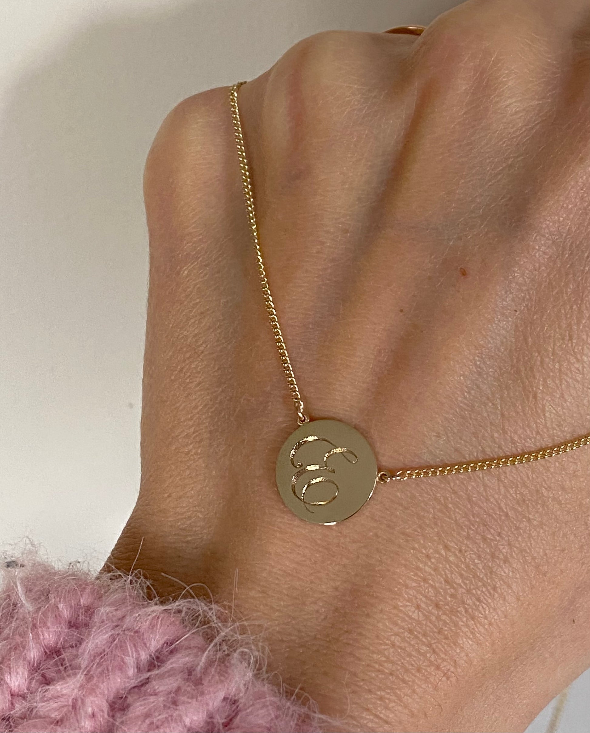 3mm polished gold disc pendant necklace with hand-engraved initial, on a curb chain