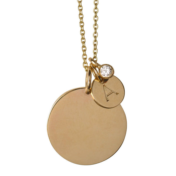 Gold necklace with round pendants and a diamond on a white background
