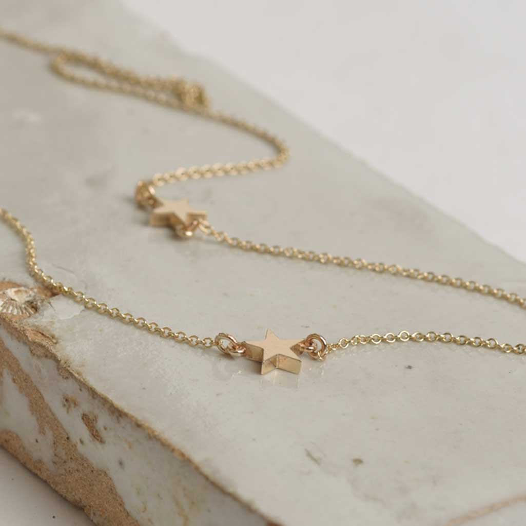 Two star solid gold necklace on delicate trace chain