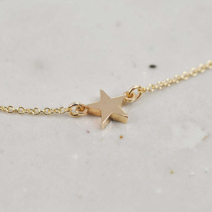 Solid recycled gold single star necklace on fine chain